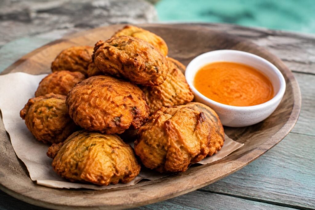 Bajan fish cakes, fluffy salt-cod fritters dipped in pepper sauce, Barbados snack, anime style